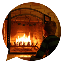 child sitting in front of a fire place