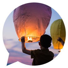 boy sending off chinese lantern