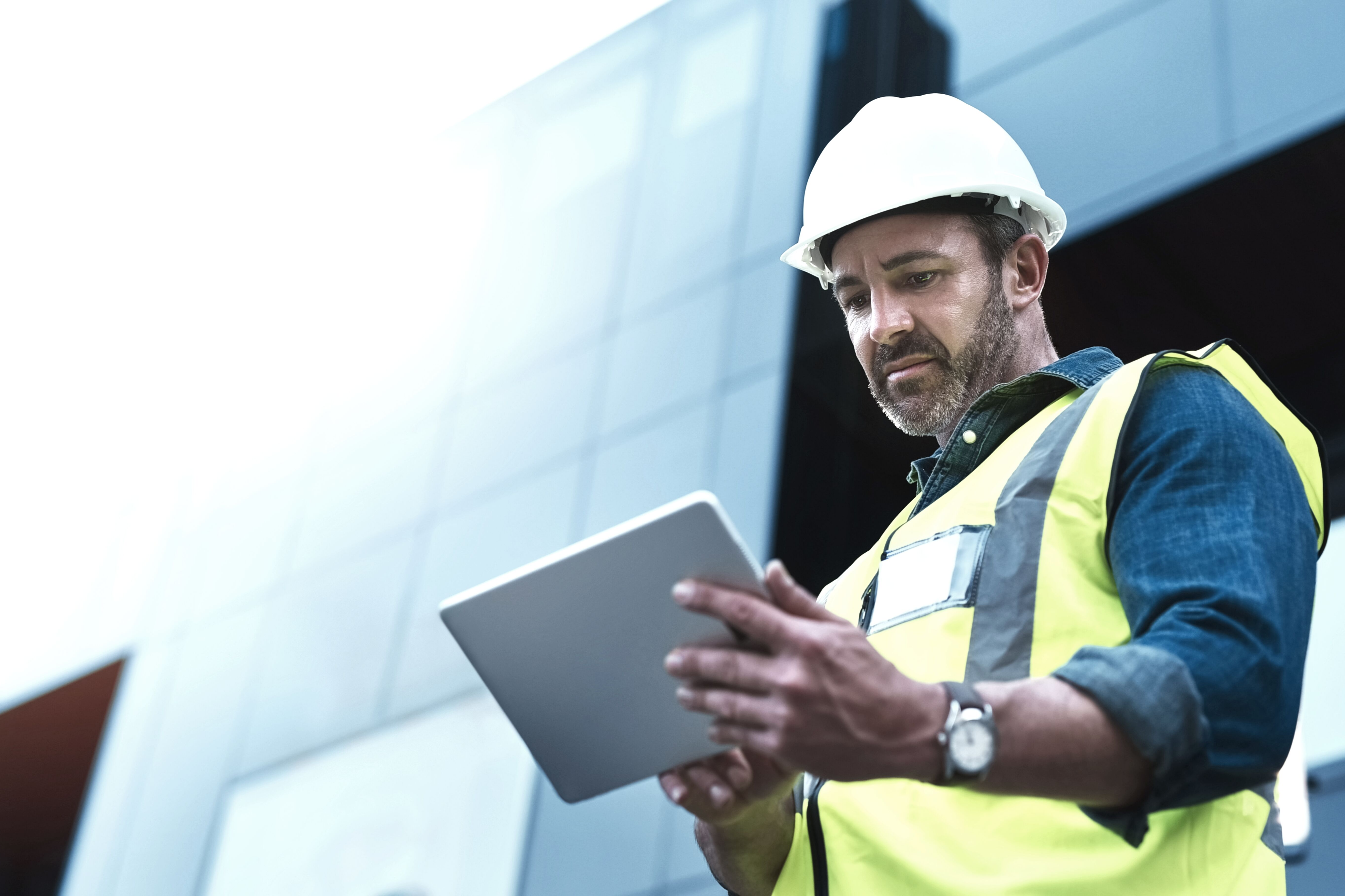 Construction man holding tablet