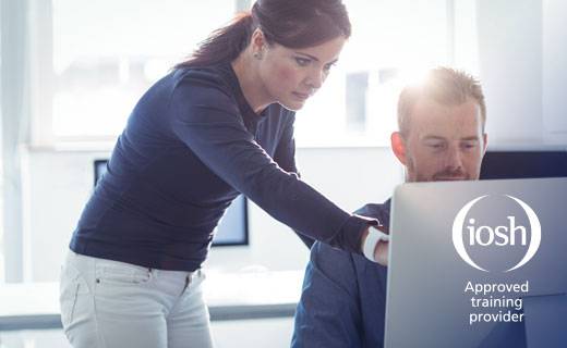 Woman showing a business man something on screen