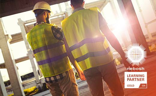 Two men in high vis jackets on construction site