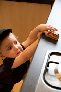 A picture of a child reaching for a box of matches.
