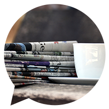 newspapers and a cup of coffee