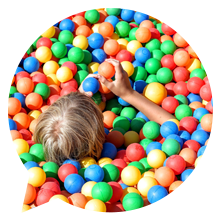 A picture of a child in a ball pool.