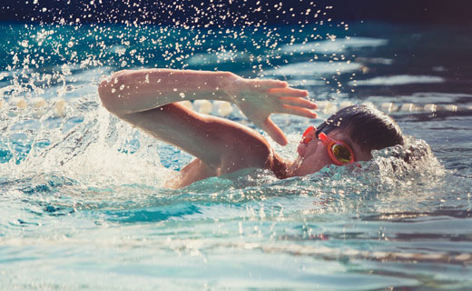 boy swimming in pool