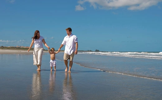 parents-and-child-on-beach-thumb